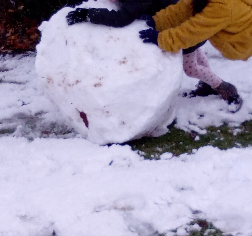 Zwei Kinder rollen eine große Schneekugel (Foto: Katharina Gebel)